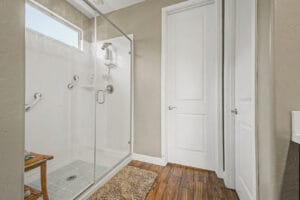 Walk-in shower in the primary suite of this move-in-ready East Mesa home