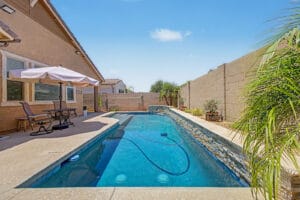 Sparkling in-ground pool with low-maintenance desert landscaping in East Mesa