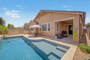 Backyard pool and covered patio at a single-level home in Cadence at Gateway, Mesa