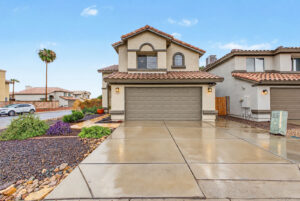 Front exterior of 5003 W Wikieup Lane, Glendale, AZ 85308, with two-car garage and desert landscaping