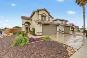 Two-story Glendale, AZ home with arched entry and low-water front landscaping
