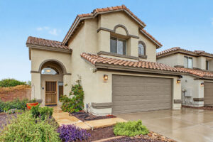 Arched front entry and two-car garage at 5003 W Wikieup Lane, Glendale