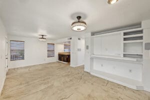 Family room with built-in entertainment wall, open to the dining area and kitchen