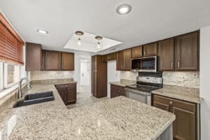 Updated kitchen with granite counters, pantry cabinet and stainless appliances at 5003 W Wikieup Lane