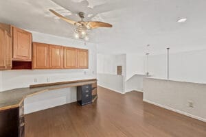 Loft office with built-in desk and cabinets, open to the living room below