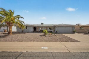 Front exterior and yard of a 2-bedroom Dreamland Villa home in Mesa