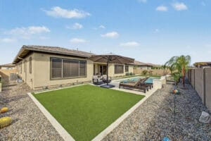 Resort-style backyard with heated pool, putting green and covered patio on a 15,000 sq ft lot at 1255 E Mead Dr, Gilbert, AZ