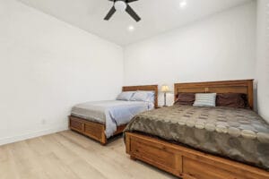 Furnished second bedroom with ceiling fan