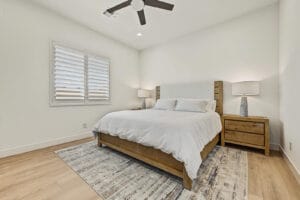 Third bedroom with plantation shutters and ceiling fan