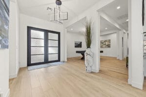 Iron-and-glass double front doors off the private paver courtyard