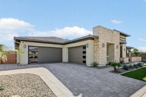 Two 2-car garages with modern glass-panel doors and an RV gate