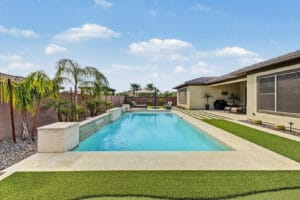 Heated pool with two sheer-descent water features and baja shelf