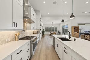 Chef’s kitchen with two large islands and white shaker cabinetry