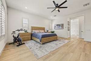 Primary bedroom suite with wood-like vinyl plank flooring