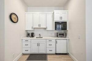 Generational suite kitchenette with sink, cabinetry, microwave and under-counter refrigerator