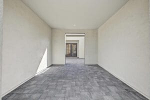 Covered zaguán-style entry with private paver courtyard