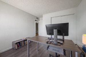 Home office bedroom with a view of the doorway and hall bathroom beyond
