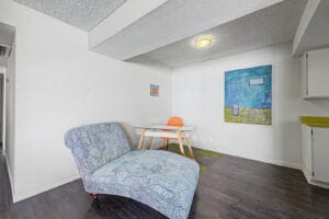 Dining nook with wood-look flooring, ceiling light, and space for a table next to the kitchen