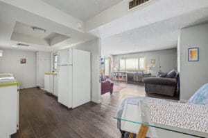 Dining nook with wood-look flooring, ceiling light, and space for a table next to the kitchen