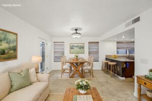 Virtually staged dining area with farmhouse table, open to the kitchen breakfast bar