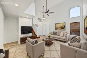 Virtually staged living room with soaring ceilings, sofa and arched clerestory windows