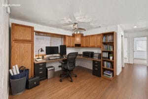 Upstairs loft virtually staged as a home office with built-in desk and bookshelf